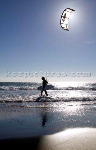 Kite surfer walking on a sandy beach in Tarifa Spain near Gibraltar