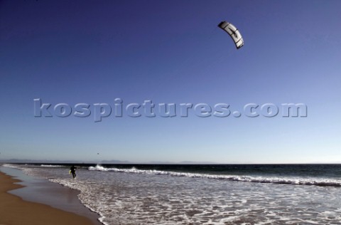 Kite surfer walking on a sandy beach in Tarifa Spain near Gibraltar