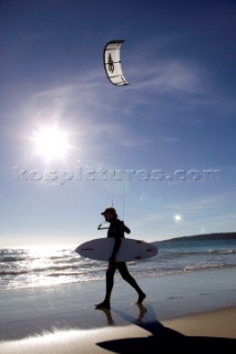 Kite surfer walking on a sandy beach in Tarifa, Spain, near Gibraltar.