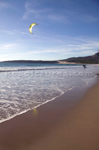 Kite surfer walking on a sandy beach in Tarifa Spain near Gibraltar