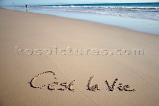 Cest La Vie its life sign writing message on a sandy beach in Tarifa, Spain, near Gibraltar.