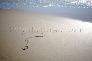 Question mark sign writing message on a sandy beach in Tarifa, Spain, near Gibraltar.