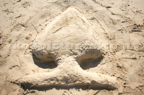 Christmas tree club sign writing message on a sandy beach in Tarifa Spain near Gibraltar