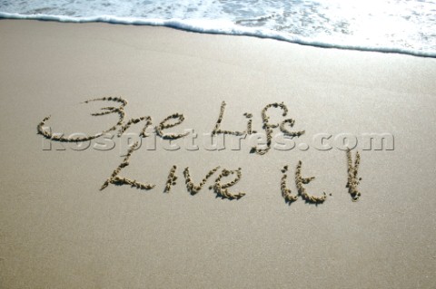 One Life  Live it sign writing message on a sandy beach in Tarifa Spain near Gibraltar