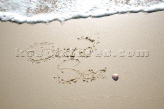 Sea Sand sign writing message on a sandy beach in Tarifa, Spain, near Gibraltar.