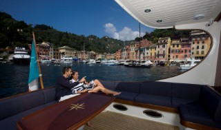 A romantic couple relaxing onboard a Vicel 72 classic motor yacht.  Model Released.