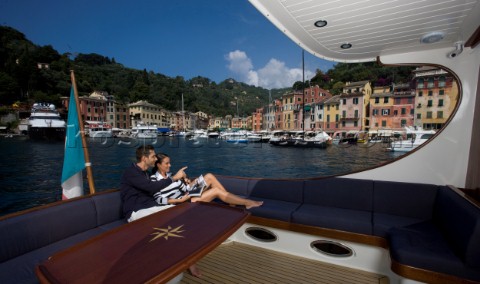 A romantic couple relaxing onboard a Vicel 72 classic motor yacht  Model Released