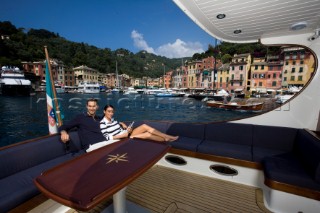 A romantic couple relaxing onboard a Vicel 72 classic motor yacht.  Model Released.