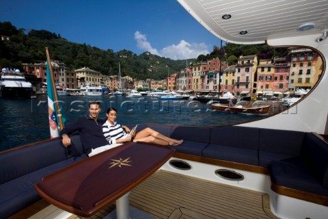 A romantic couple relaxing onboard a Vicel 72 classic motor yacht  Model Released