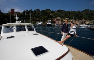 A romantic couple relaxing onboard a Vicel 72 classic motor yacht.  Model Released.