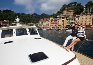 A romantic couple relaxing onboard a Vicel 72 classic motor yacht.  Model Released.