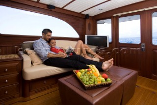 A romantic couple relaxing onboard a Vicel 72 classic motor yacht.  Model Released.