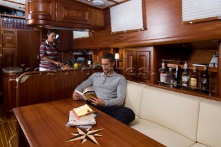 A romantic couple relaxing onboard a Vicel 72 classic motor yacht.  Model Released.