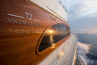 A romantic couple relaxing onboard a Vicel 72 classic motor yacht.  Model Released.