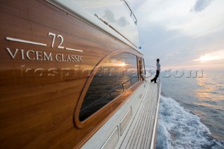 A romantic couple relaxing onboard a Vicel 72 classic motor yacht.  Model Released.