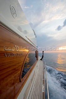 A romantic couple relaxing onboard a Vicel 72 classic motor yacht.  Model Released.