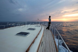 A romantic couple relaxing onboard a Vicel 72 classic motor yacht.  Model Released.