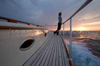 A romantic couple relaxing onboard a Vicel 72 classic motor yacht.  Model Released.