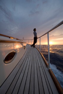 A romantic couple relaxing onboard a Vicel 72 classic motor yacht.  Model Released.