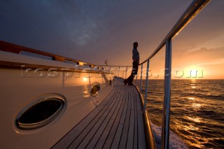 A romantic couple relaxing onboard a Vicel 72 classic motor yacht.  Model Released.