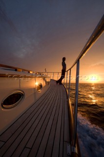 A romantic couple relaxing onboard a Vicel 72 classic motor yacht.  Model Released.