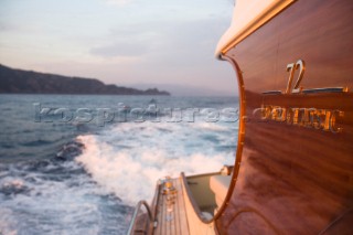 A romantic couple relaxing onboard a Vicel 72 classic motor yacht.  Model Released.