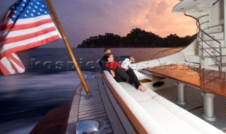 A romantic couple relaxing onboard a Vicel 72 classic motor yacht.  Model Released.