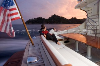 A romantic couple relaxing onboard a Vicel 72 classic motor yacht.  Model Released.