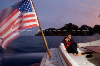 A romantic couple relaxing onboard a Vicel 72 classic motor yacht.  Model Released.