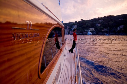 A romantic couple relaxing onboard a Vicel 72 classic motor yacht  Model Released