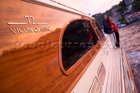 A romantic couple relaxing onboard a Vicel 72 classic motor yacht  Model Released