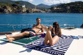 A romantic couple relaxing onboard a Vicel 72 classic motor yacht.  Model Released.