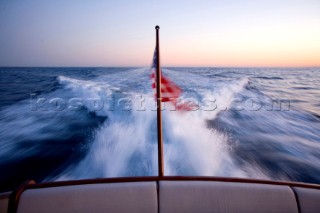 A romantic couple relaxing onboard a Vicel 72 classic motor yacht.  Model Released.