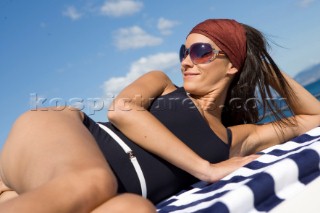 Lifestyle girl female onboard a Vicem 72 classic motor yacht Model Released.