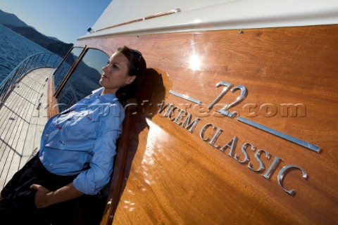 Lifestyle girl female onboard a Vicem 72 classic motor yacht Model Released