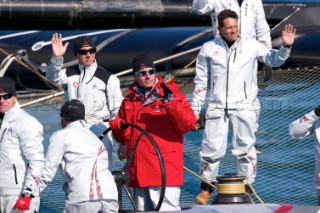 FEBRUARY 12TH 2010, VALENCIA, SPAIN: Ernesto Bertarelli (in red) on Alinghi 5 catamaran during the 1st match of the 33rd Americas Cup in Valencia, Spain.