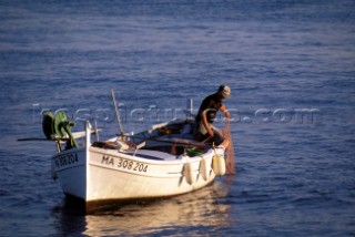 Fishing Dinghy Boat  Cassis, France    A fisherman brings in his nets in Cassis, France