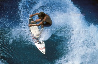 Surfing carving through a wave