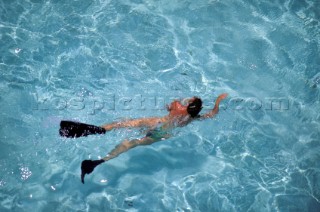 Aerial view of female snorkeller on surface of clear shallow water