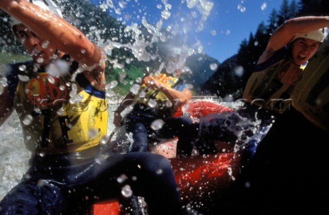 Action onboard white water raft in Austrian mountains