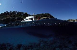 Above and below the water line with Fairline Powerboat in anchorage.