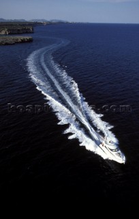 A Fairline powerboat speeds through the water leaving wash