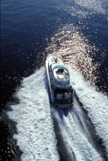 A Fairline powerboat speeds through the water leaving wash