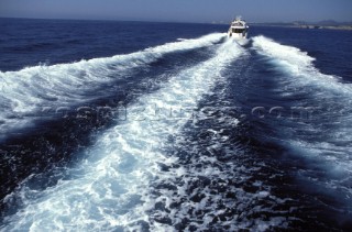 A Fairline powerboat speeds through the water leaving wash