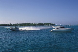 Seaplane lands by anchored Fairline Squadron 65