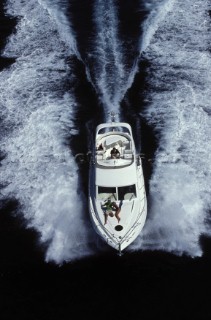 A Fairline powerboat speeds through the water leaving wash