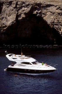 Fariline Phantom 38 at anchor in front of a cliff