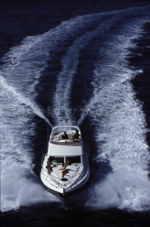 A Fairline powerboat speeds through the water leaving wash