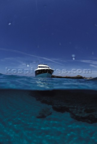 Fairline Phantom 43 at anchor in clear shallow water