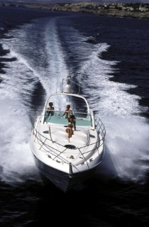 A Fairline powerboat speeds through the water leaving wash